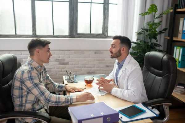 patient-in-checkered-shirt-explaining-his-problems